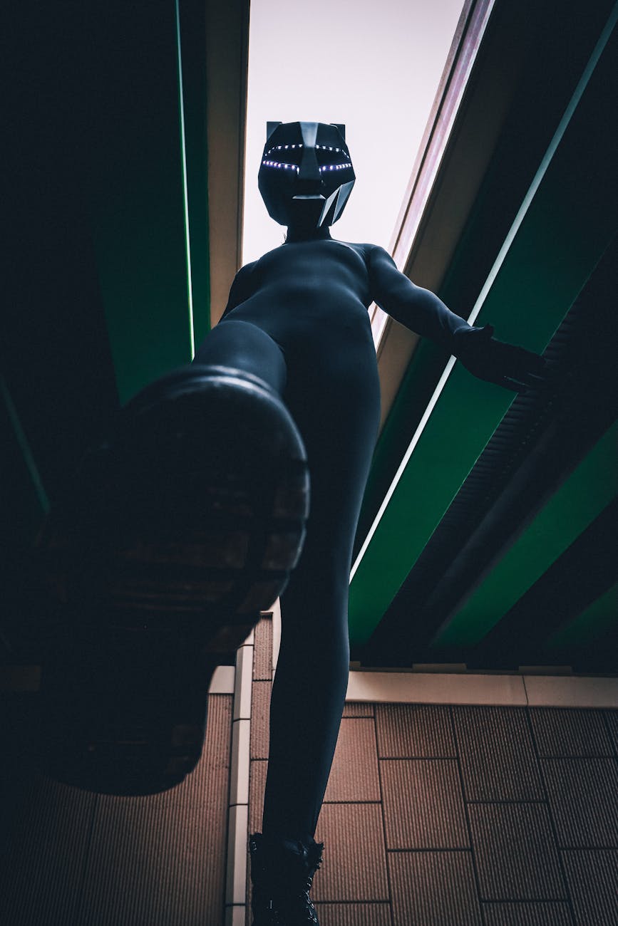 Unique perspective of a person posing in a cat mask shot from below, emphasizing footwear.